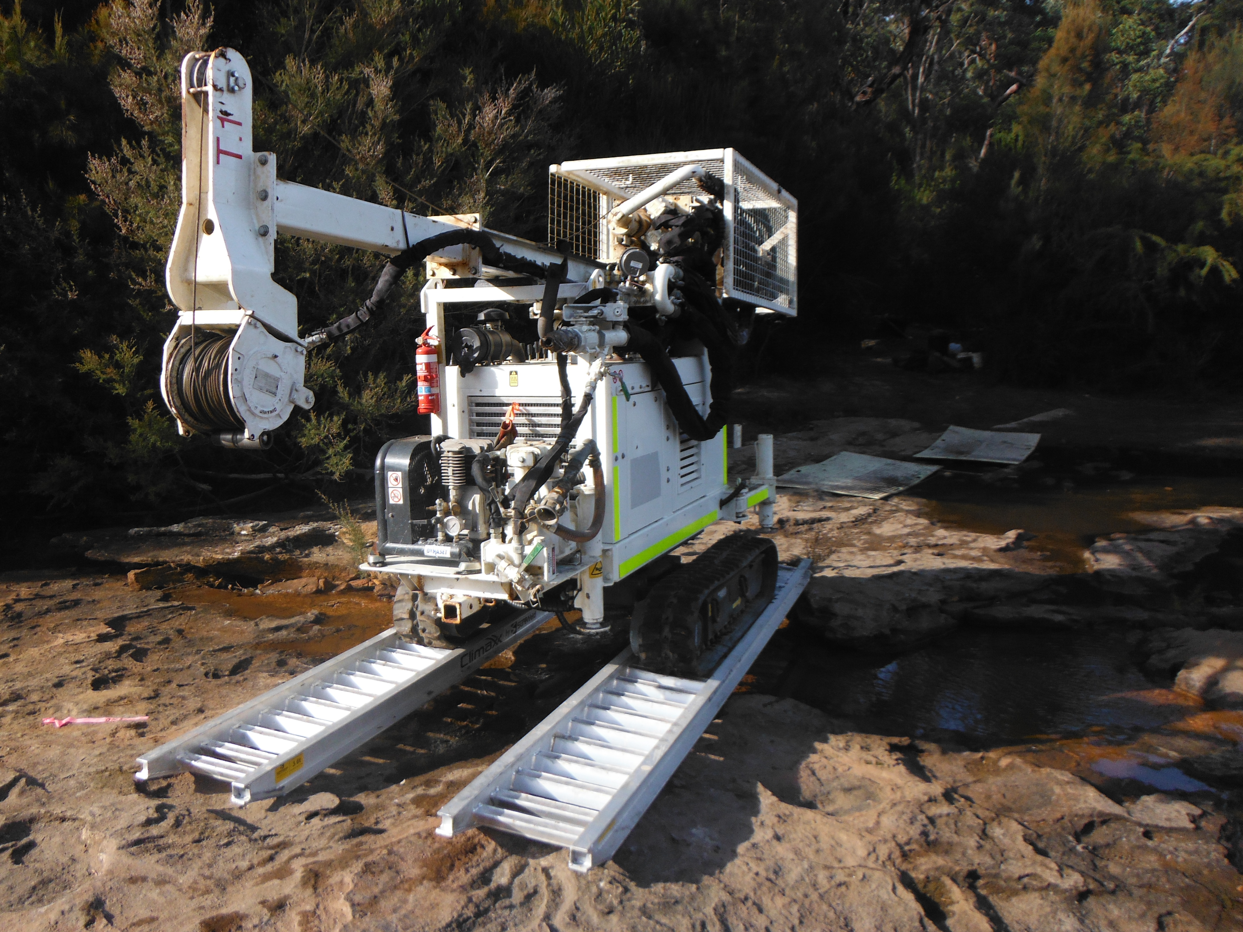 Small Diamond Rotary Auger drill on tracks over water