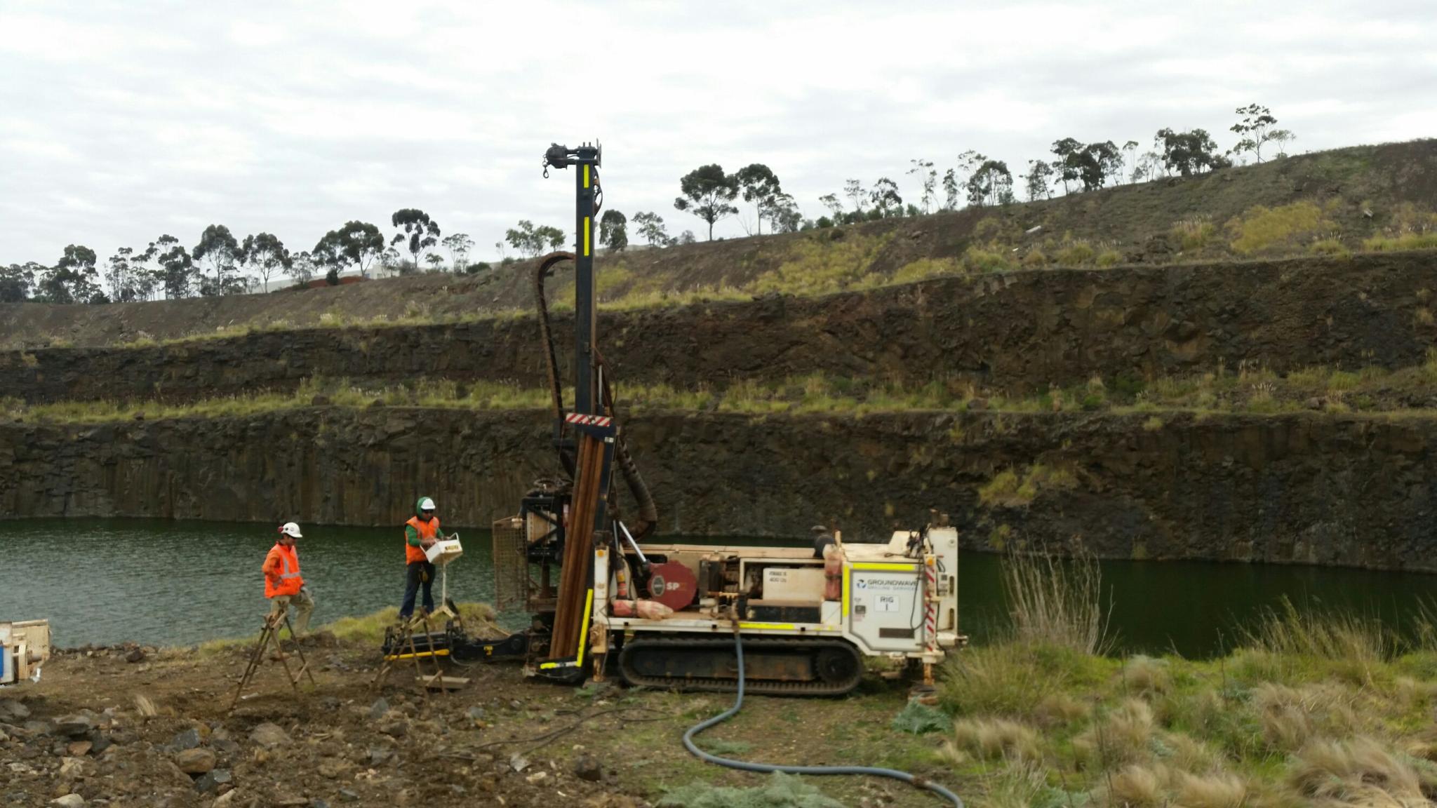Drill Rig and Driller operating on dam wall