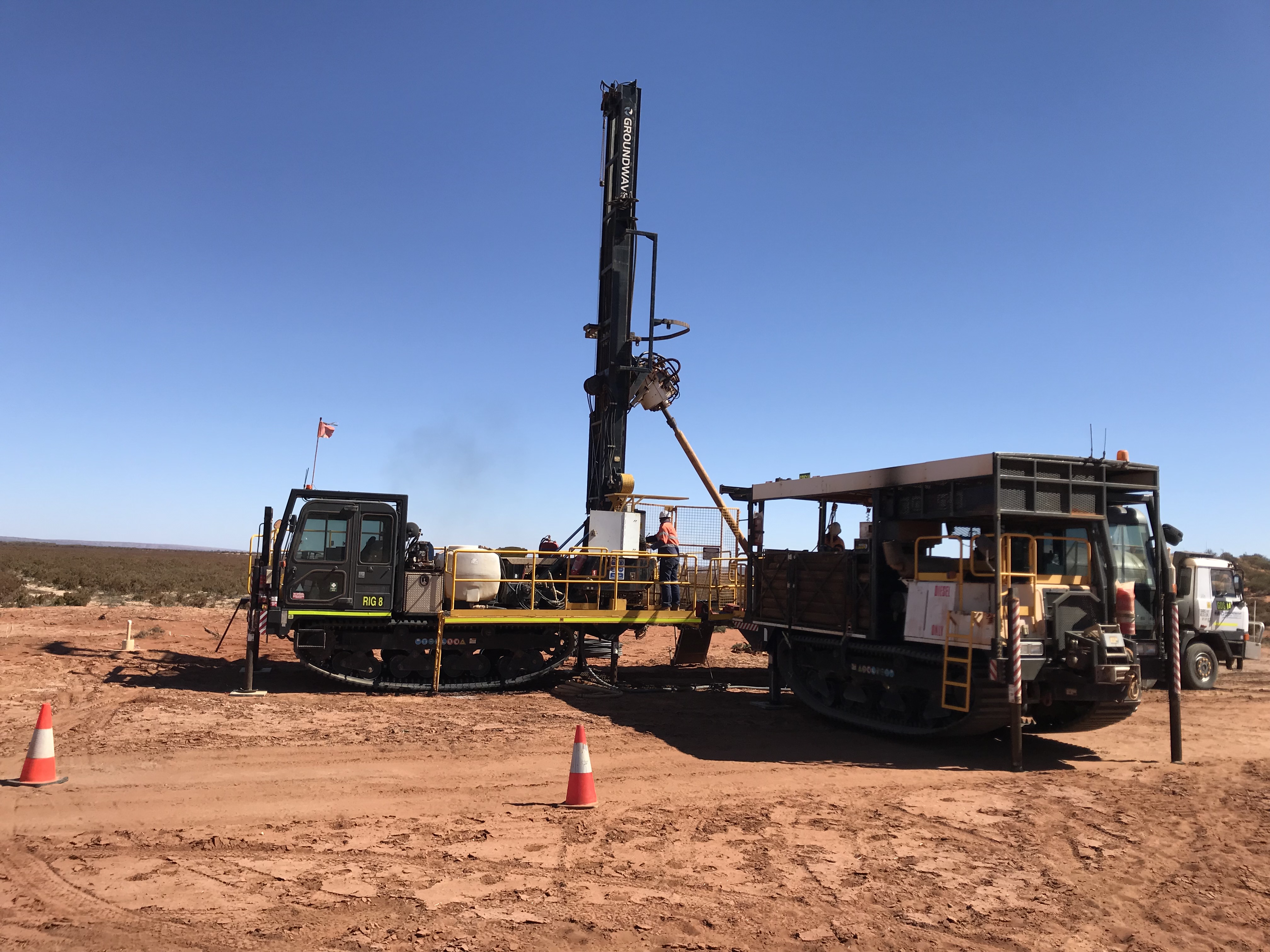 Drill Rig and support vehicles in the desert